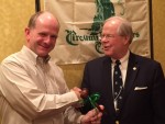 New Chapter President Kip Knudson accepts the gavel from outgoing President Samuel Watson