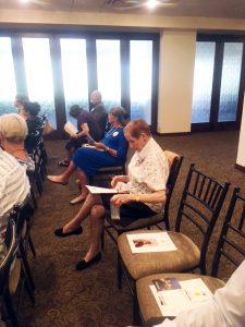 C. Kaye Jenista studying the Desert Chapter April meeting agenda at the Arizona Country Club